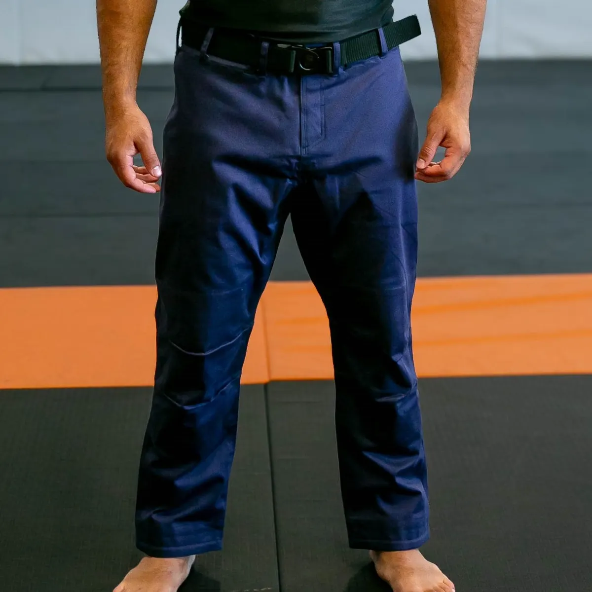 Royal FNTQ gi pants with the black belt, on the orange and black mats